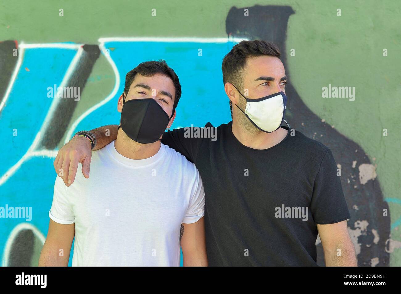 Deux amis utilisant un masque facial à l'extérieur. Concept amitié nouvelle norme Banque D'Images