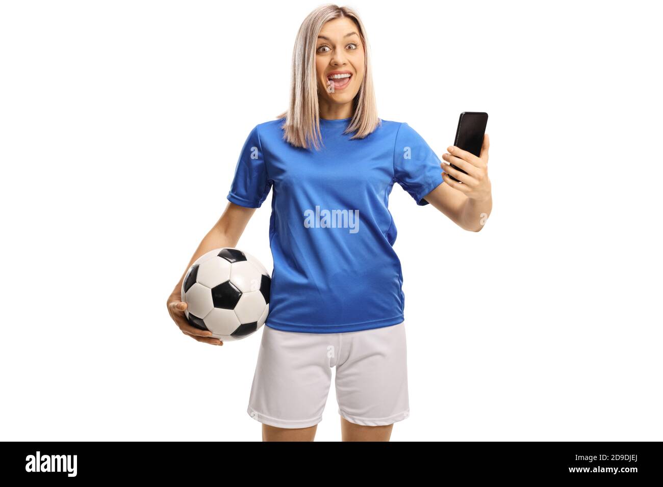 Jeune femme excitée avec un ballon de football et un smartphone isolé sur fond blanc Banque D'Images