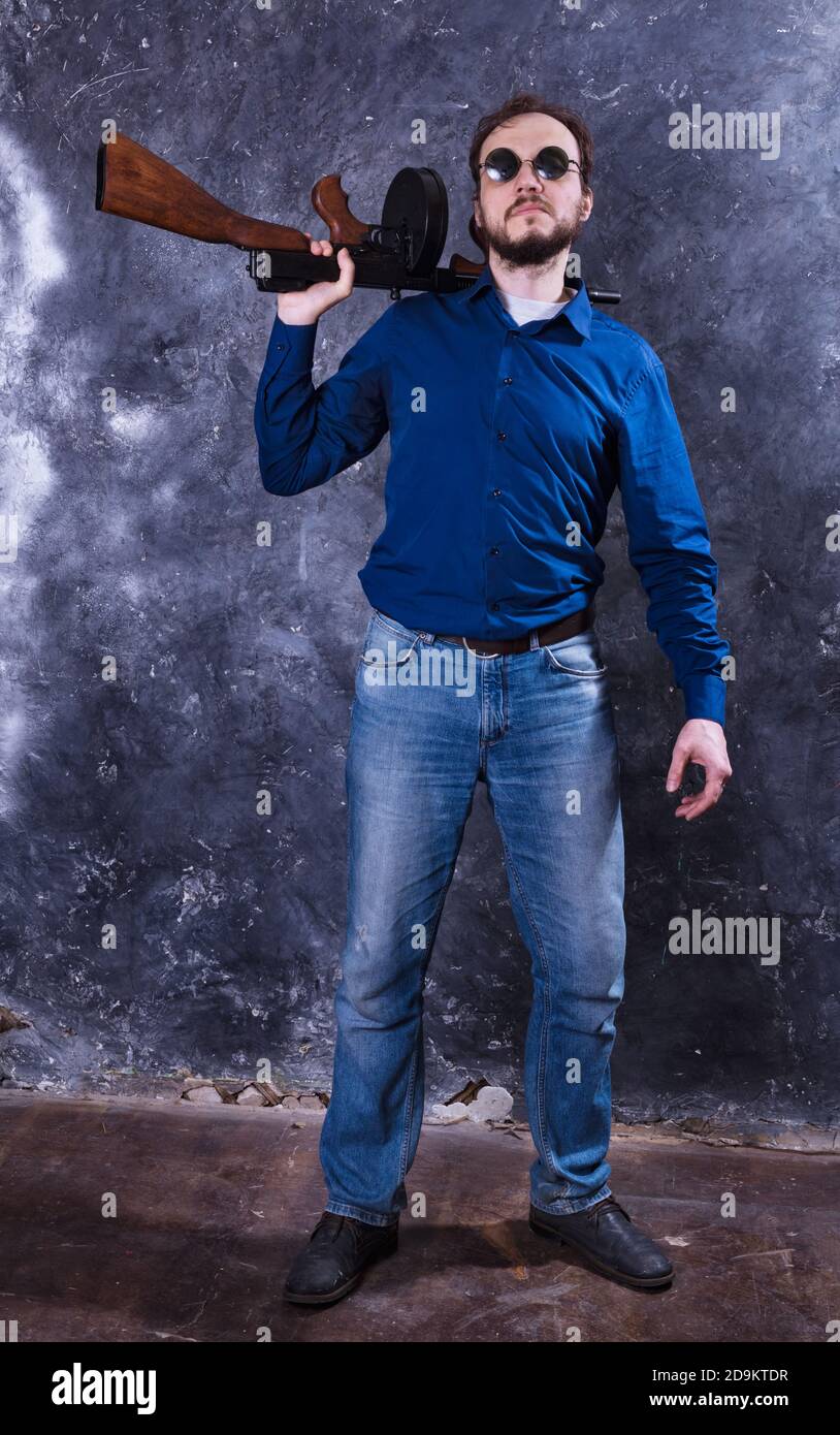 Homme mature en lunettes de soleil avec tommy Gun studio portrait Banque D'Images