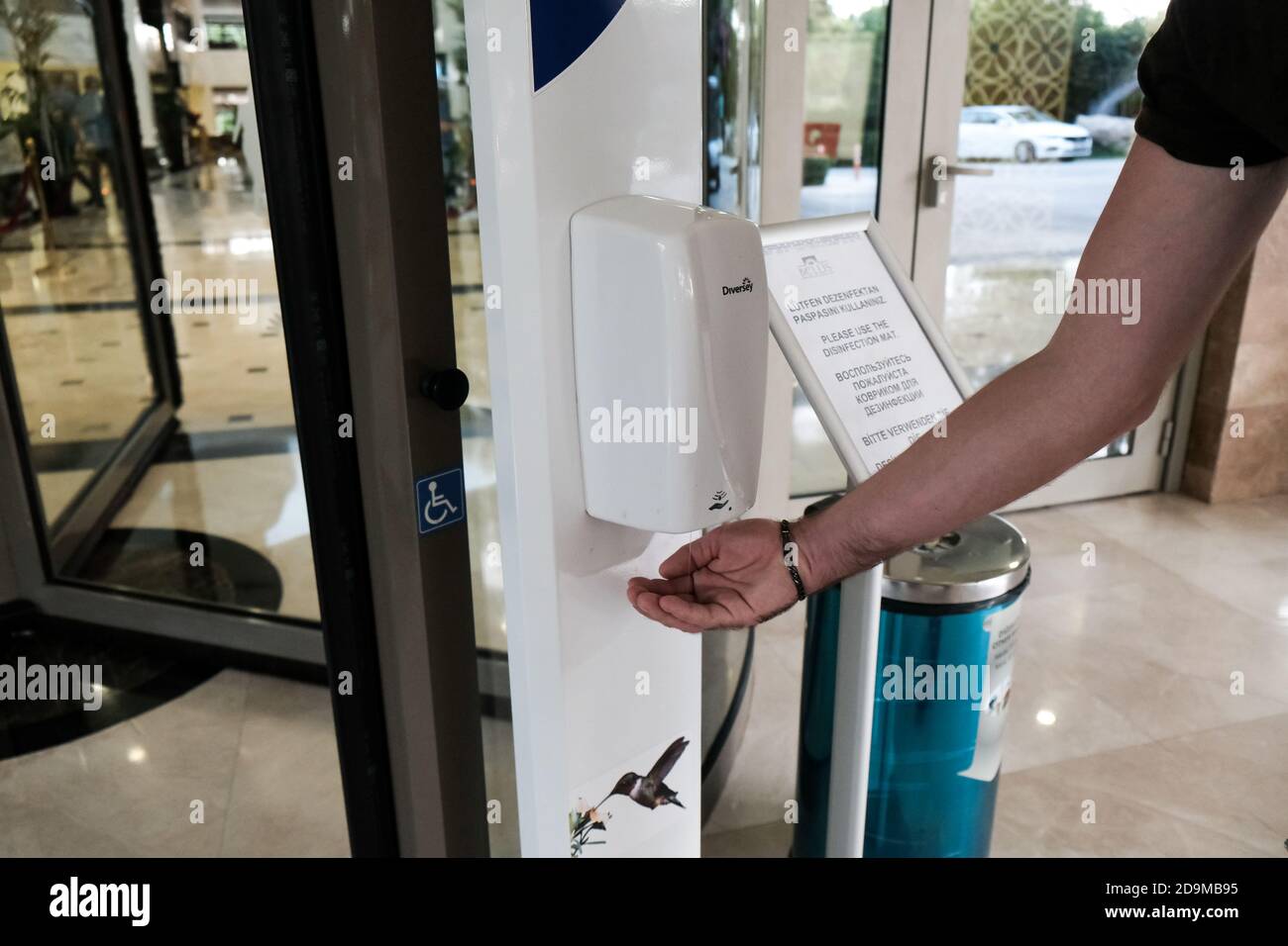 Belek, Turquie - octobre 2020 : touriste utilisant un désinfectant pour les mains à l'entrée de l'hôtel. Mesures de sécurité dans les hôtels tout compris pour prévenir la propagation du coronavirus. Banque D'Images