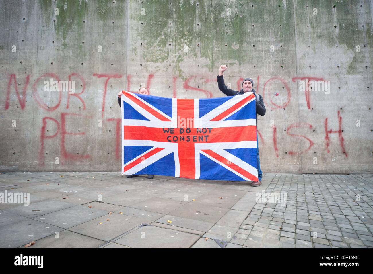 Manchester 08-11-2020, deux hommes détiennent un drapeau syndical devant le mur « le Nord n'est pas un pétri » lors de la manifestation anti-verrouillage du 8 novembre 2020 Banque D'Images