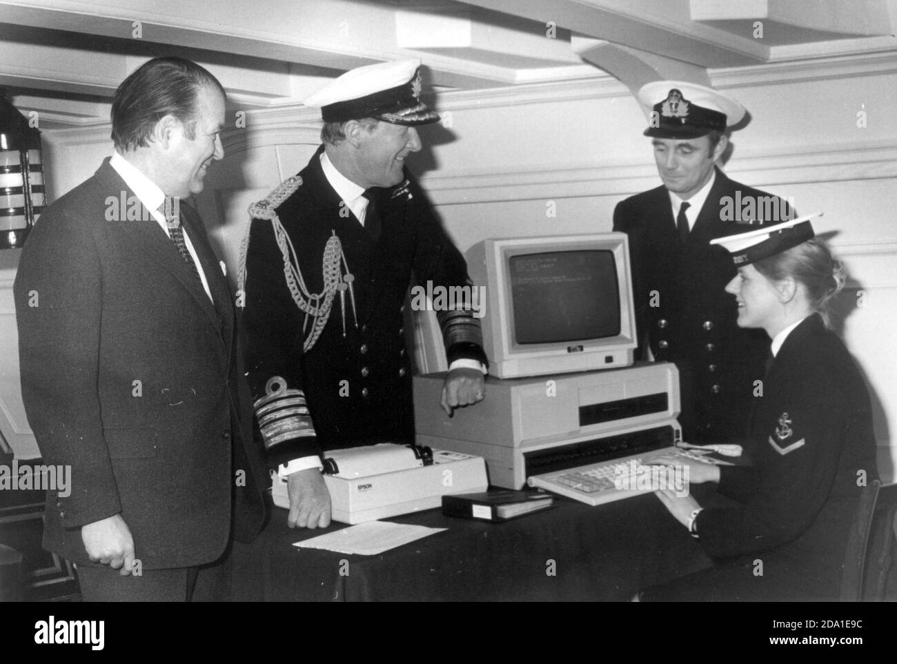 LA MARINE ROYALE REÇOIT SON PREMIER ORDINATEUR QUI EST REMIS À HMS VICTORY. L À R. FERRANTIS DIRECTEUR GÉNÉRAL, BASIL DE FERRANTI DE FERRANTI COMPUTERS COMMANDANT EN CHEF AMIRAL SIR DESMOND CASSIDI, PREMIER LT. MIKE AVANT LA VICTOIRE DE HMS, ET DIRIGEANT L'OPÉRATEUR INFORMATIQUE DE WREN KAREN BULLEY HMS VICTORY 1984 Banque D'Images