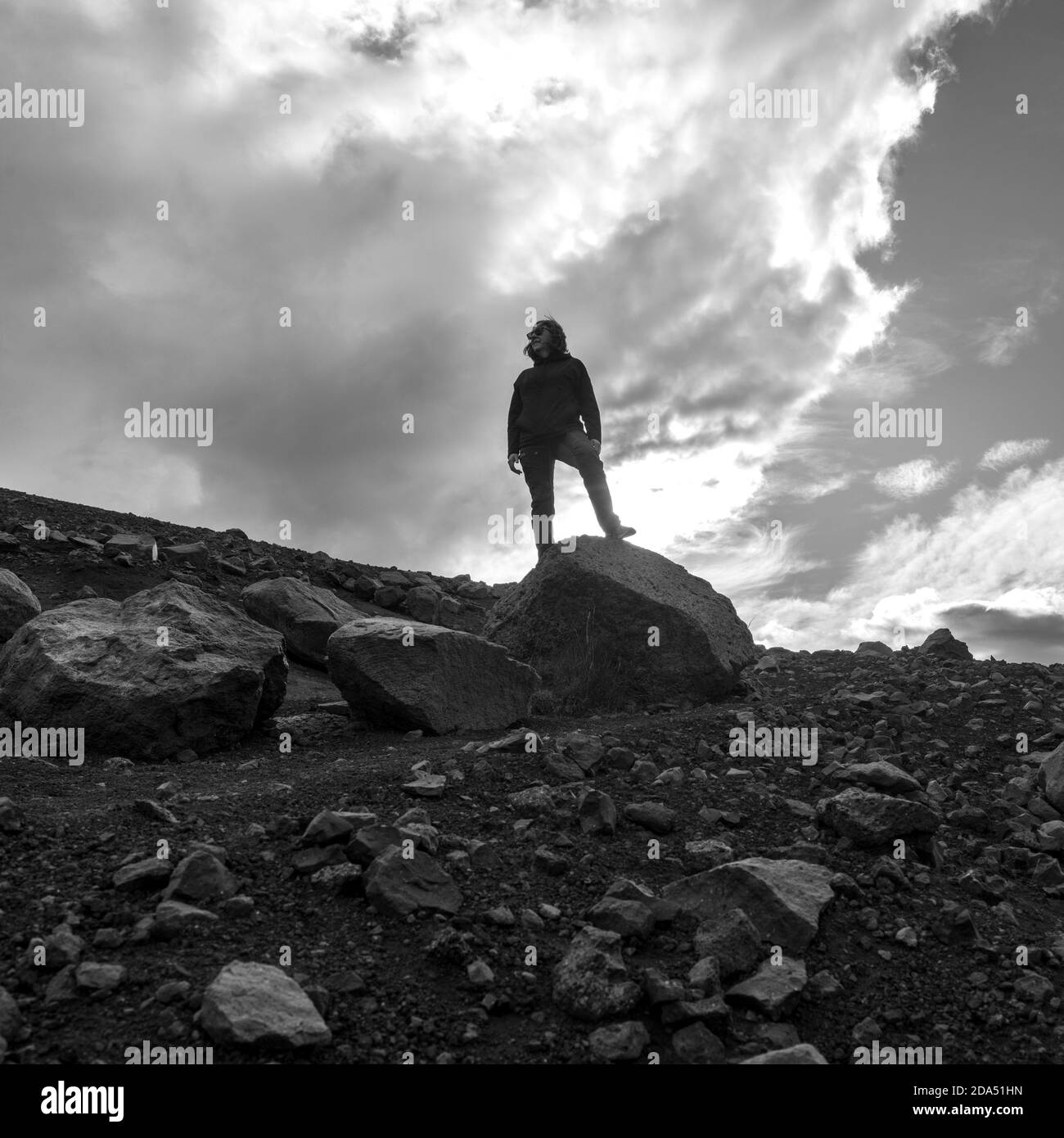 Femme debout sur la roche sous ciel nuageux, cratère de Hverfjall, Skutustaoahreppur, région nord-est, Islande Banque D'Images