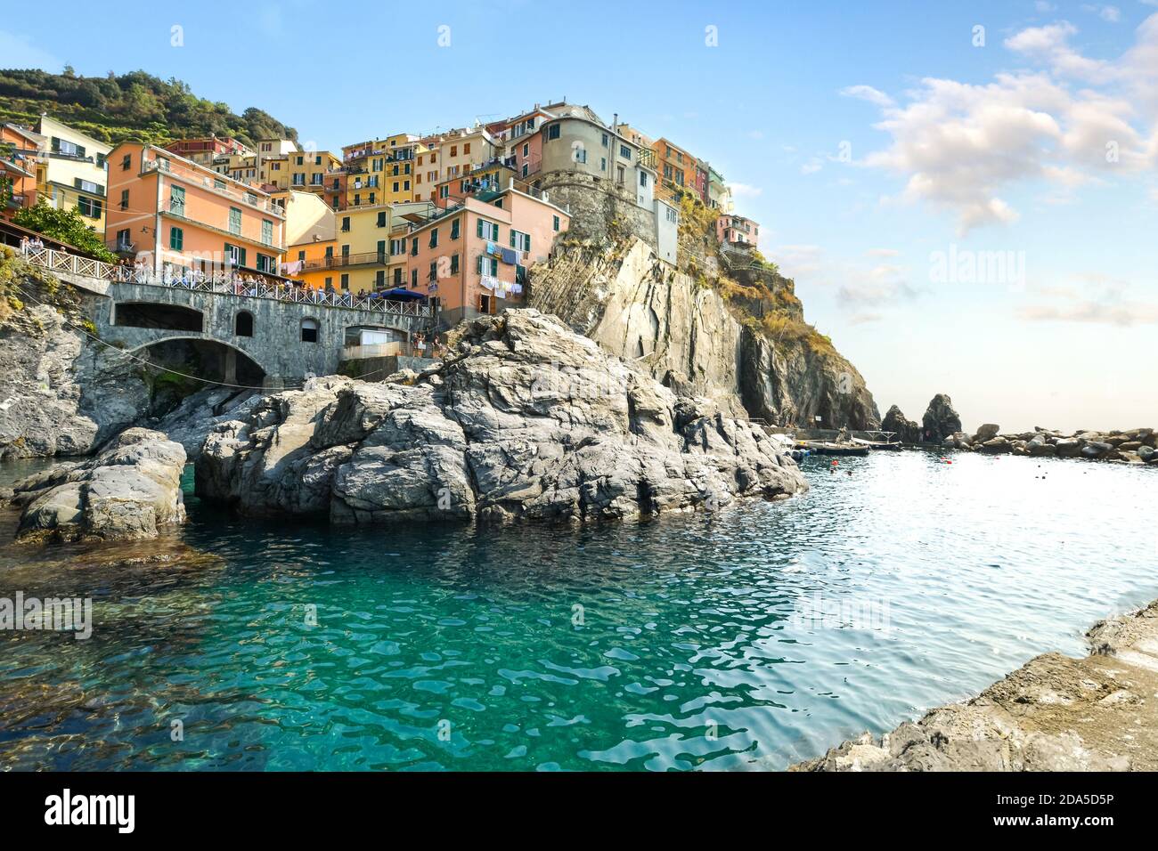 La baie turquoise et la zone de baignade au village de Manarola, l'un des cinq villages des Cinque Terre, site classé au patrimoine mondial. Banque D'Images