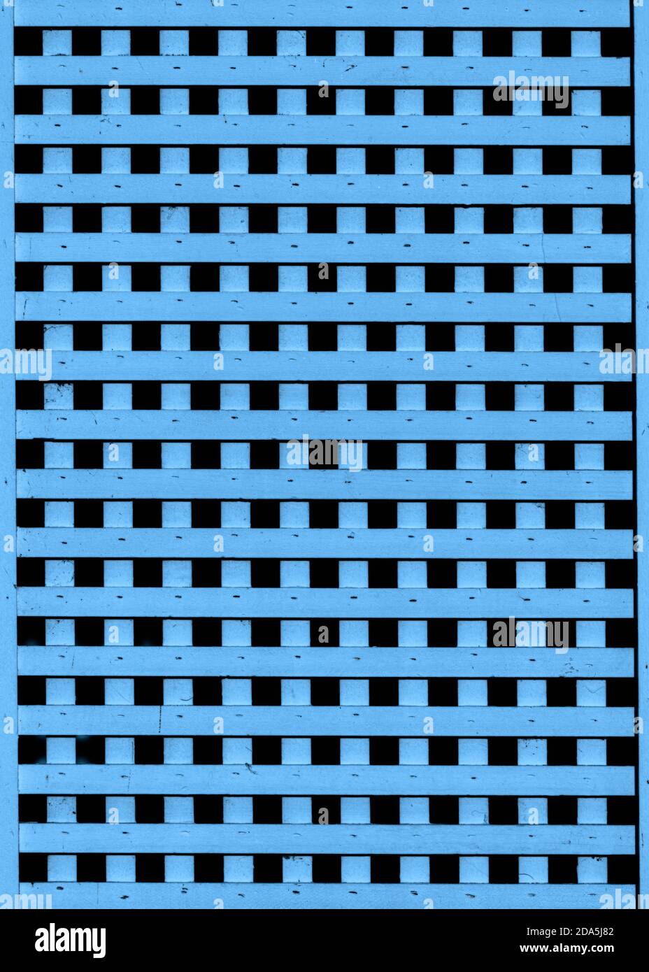 Les lattes en bois bleu forment un motif de grille répétitif abstrait sur la façade de vieux bâtiment Banque D'Images