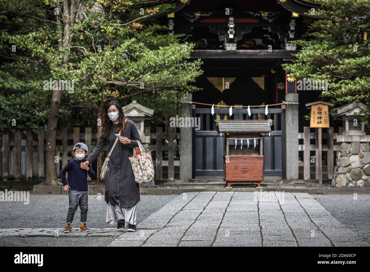 Kamakura, Japon. 6 novembre 2020. Mère et son fils portant un masque facial visitent le sanctuaire Tsurugaoka Hachimangu lors de l'événement Shichi Go San.Shichi Go san est un événement marquant qui célèbre la santé et le bien-être des enfants de trois, cinq et sept ans. Traditionnellement, les garçons et les filles de trois ans, les garçons de cinq ans et les filles de sept ans célèbrent cet événement, mais de nombreux parents aujourd'hui vont habiller tous leurs enfants en kimono en même temps, quel que soit leur âge pour obtenir des photos de famille. Les enfants s'habillez dans un kimono, prenez des photos et visitez le sanctuaire shinto Banque D'Images