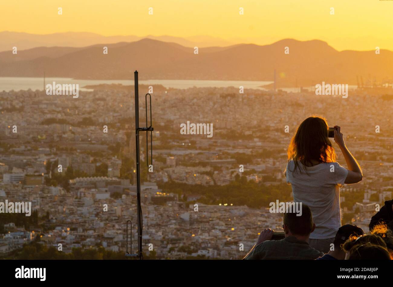 Les touristes prennent des photos sur leurs smartphones au point de vue sur la colline du Lycabette dans le centre d'Athènes en Grèce - photo: Geopix Banque D'Images