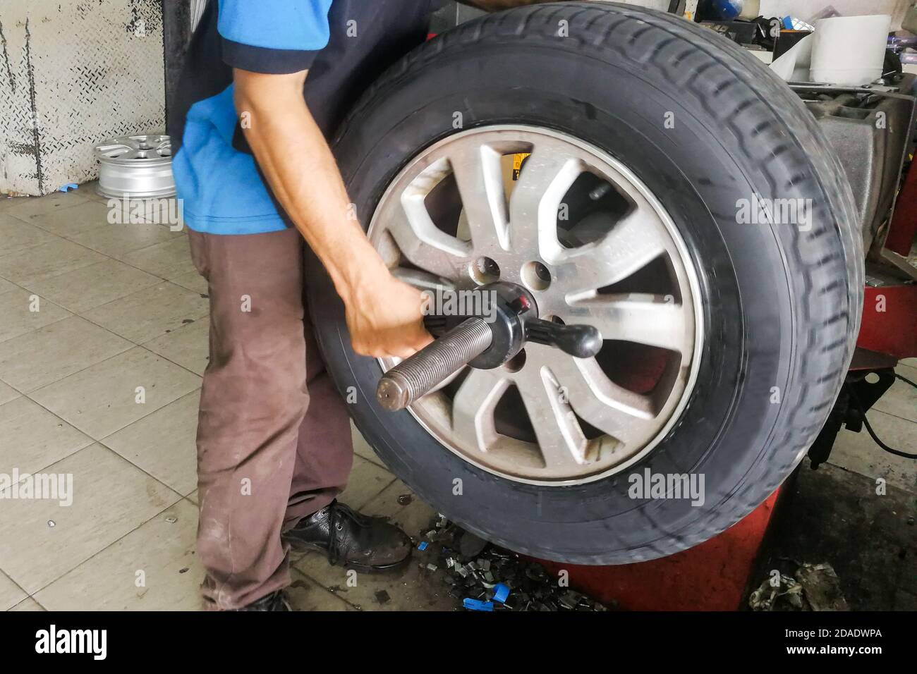Série de techniciens effectuant l'équilibrage des pneus de roue de voiture Banque D'Images
