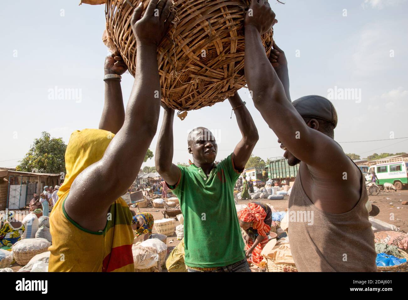 Selingue, Mali, le 25 avril 2015; des hommes chargent un bus avec des paniers de produits à la fin de la journée de marché. Banque D'Images
