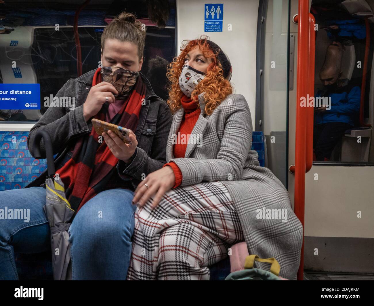 Passagers du métro de Londres portant un masque facial et une distance sociale. Banque D'Images
