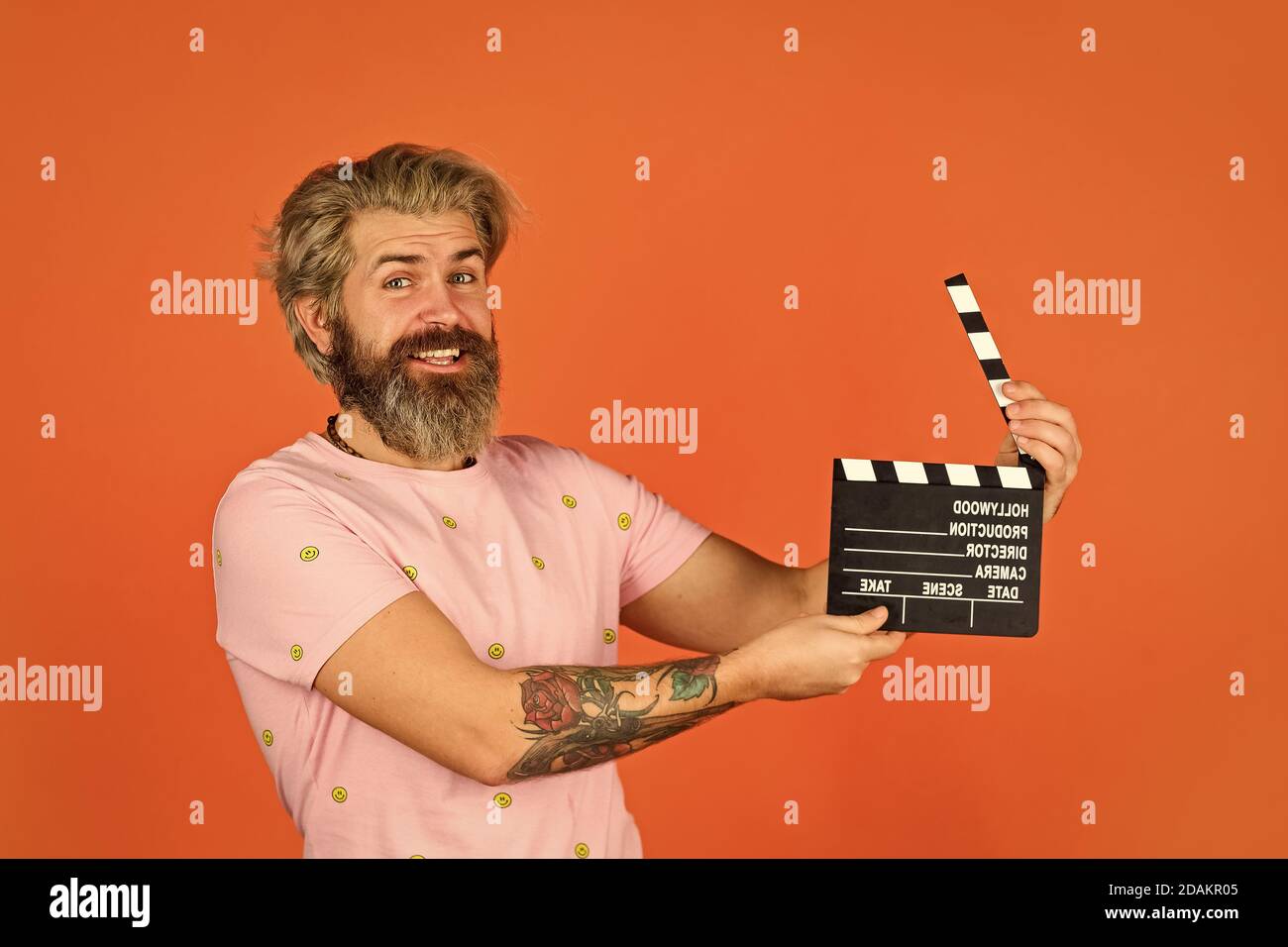 Comédie ou drame. Regarder le film. Réalisateur. Moulage de l'acteur. Scène de prise de vue. Série préférée. Production cinématographique. Producteur créatif. Un homme barbu tient un clapper de film. Machine à film. Espace de copie du panneau de commande. Banque D'Images
