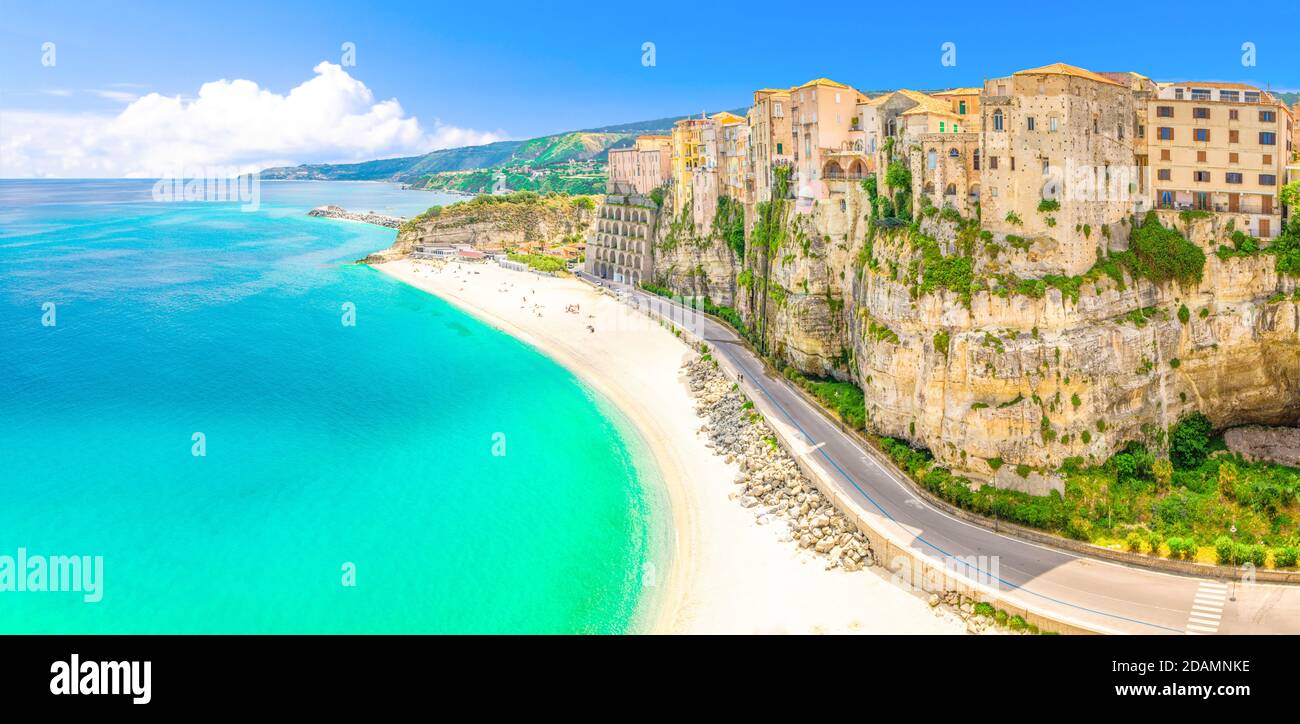 Vue panoramique aérienne de la ville de Tropea et de la plage de la mer Tyrrhénienne avec l'eau turquoise azure, maisons colorées bâtiments sur le haut grand ro Banque D'Images