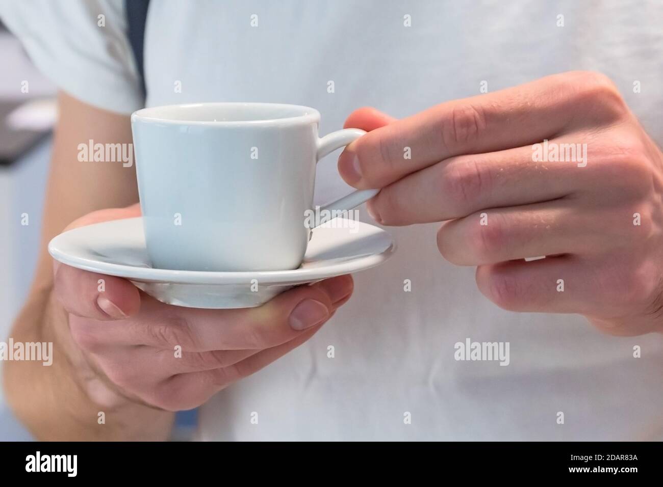tasse de café blanc dans les mains des hommes Banque D'Images