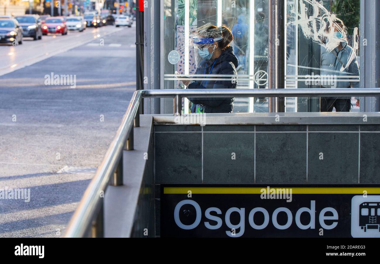 Toronto, Canada. 14 novembre 2020. Une femme portant un masque facial et un masque facial attend un autobus à une gare routière de Toronto, au Canada, le 14 novembre 2020. Le Canada a signalé 3,041 nouveaux cas de COVID-19 le samedi midi, portant le total à 290,596 cas, dont 10,888 décès, selon CTV. Credit: Zou Zheng/Xinhua/Alamy Live News Banque D'Images