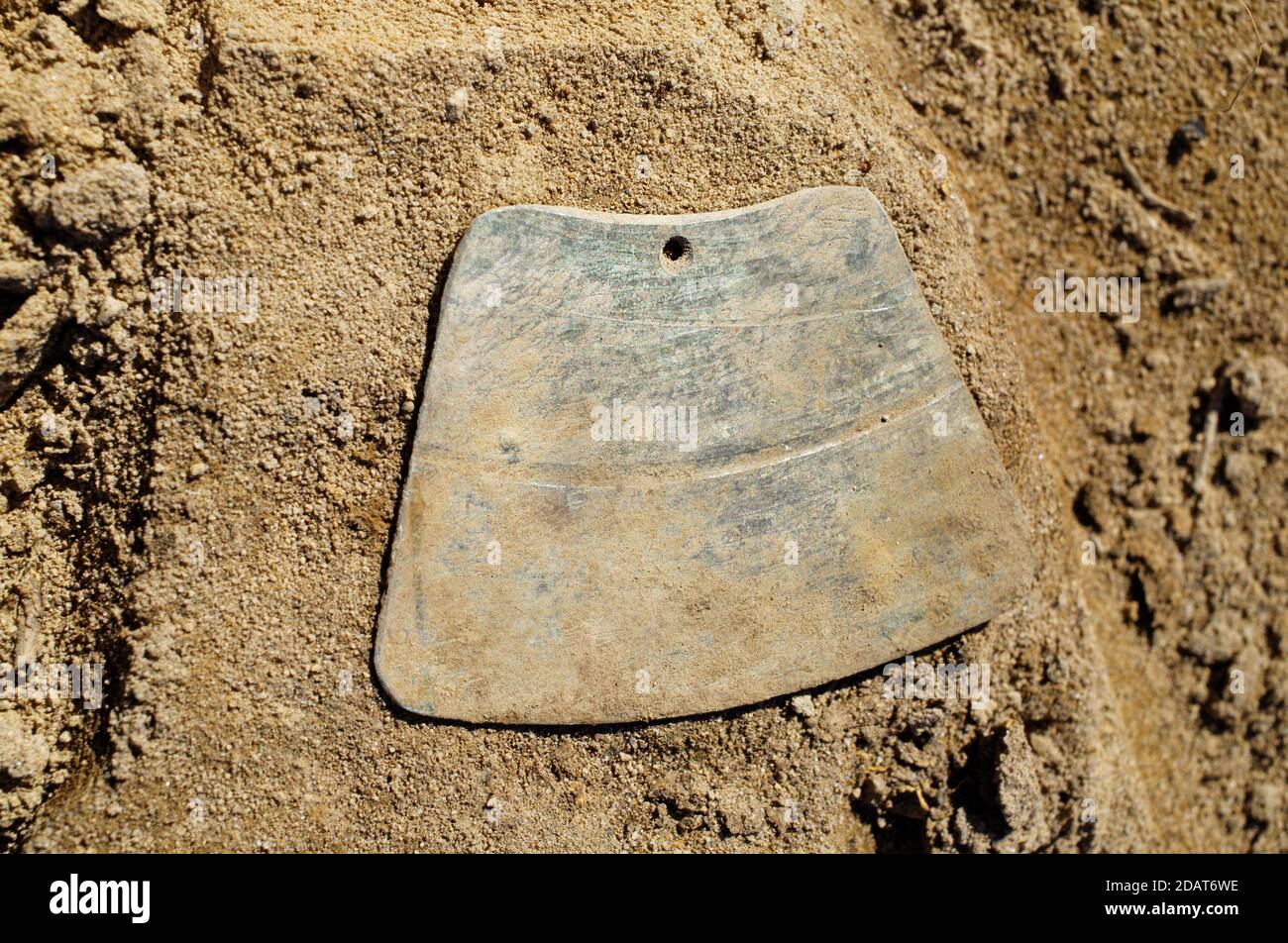 Découverte archéologique de l'âge de fer précoce - pendentif en bronze usiné avec un trou Banque D'Images