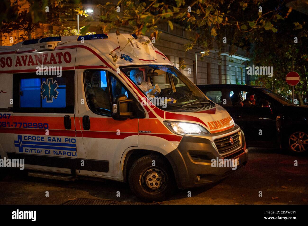 Naples, Italie. 14 novembre 2020. L'ambulance transportant le suspect Covid-19 a été vue près d'une voiture dans une rue étroite.le 14 octobre, une ambulance pour un cas suspect de Covid-19 a été vue dans le quartier branché de Vomero à Naples. L'augmentation rapide des cas de Covid19 a entraîné un débordement de personnes vers les hôpitaux locaux, ce qui a entraîné l'inclusion de Naples et de la Campanie dans la zone à haut risque (zone rouge), qui commence le 15 novembre. Crédit : SOPA Images Limited/Alamy Live News Banque D'Images