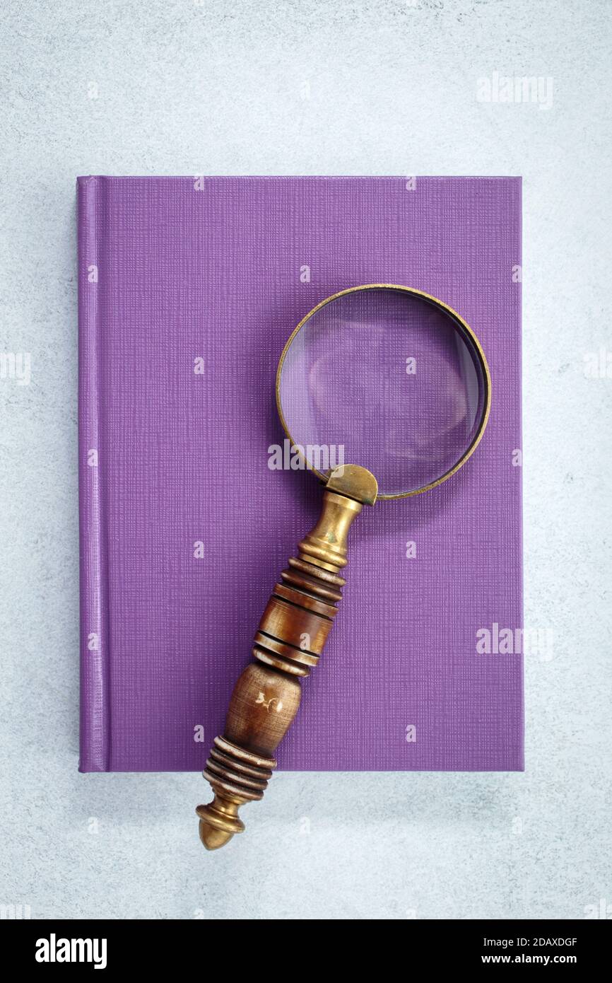 Loupe sur carnet violet Banque D'Images