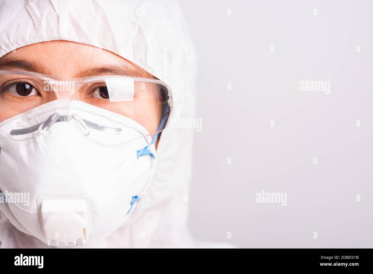 Gros plan visage de femme de portrait médecin ou scientifique dans la suite EPI uniforme porter masque visage N 95 protection et lunettes dans le laboratoire, coronavirus ou COVID-1 Banque D'Images