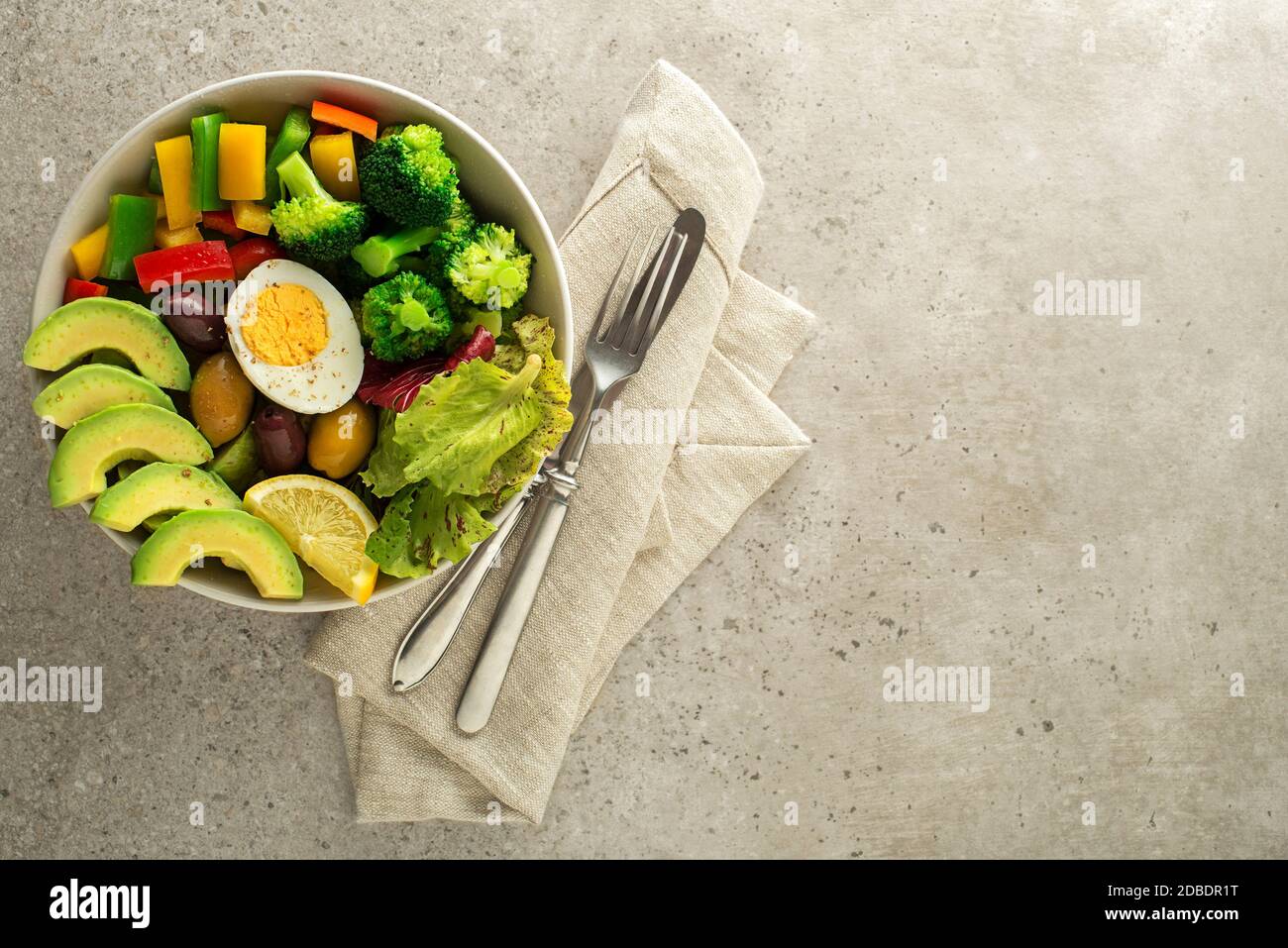Repas de salade sain avec œufs, avocat et légumes frais mélangés sur fond gris vue du dessus. Concept de repas sain Banque D'Images