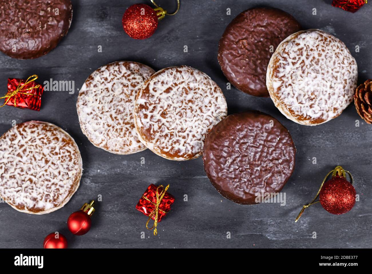 Biscuits ronds d'épices allemands appelés « Lebkuchen » avec du blanc et du chocolat Vitrages entourés d'une décoration de Noël de saison Banque D'Images