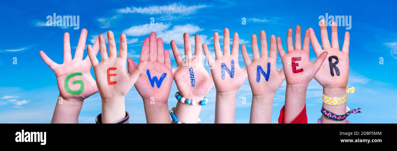 Enfants mains construire coloré German Word Gewinner signifie gagnant. Ciel bleu comme arrière-plan Banque D'Images