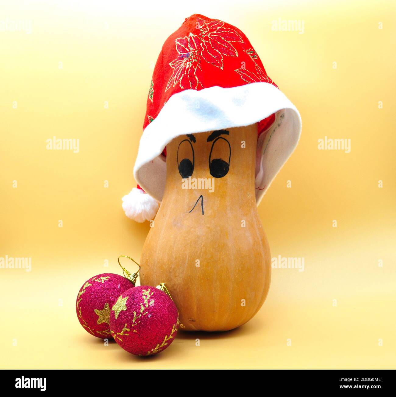 Citrouille souriante avec chapeau de noël et décorations isolées sur neutre arrière-plan orange Banque D'Images