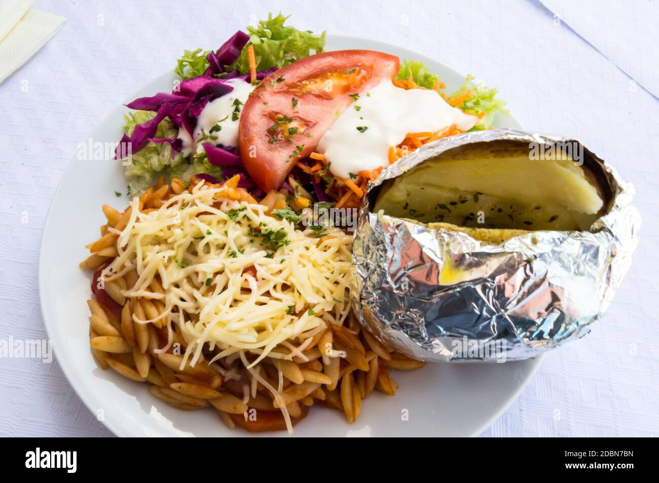 Assiette de légumes crus, tomates, pâtes grecques, pommes de terre Banque D'Images