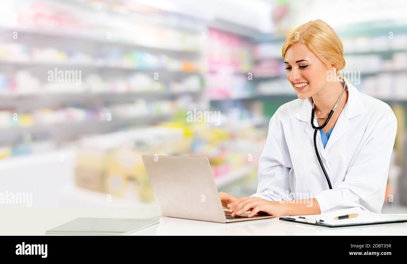 Votre pharmacien ou votre médecin à l'aide d'un ordinateur portable à la pharmacie prix. Le personnel médical et pharmaceutique de la santé publique. Banque D'Images