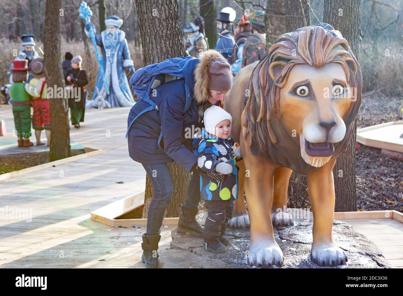 Moscou, Russie. 18 novembre 2020. Une femme et son enfant jouent autour d'une sculpture de lion lors de l'ouverture de la 'Fée Tales Path' à la 'Résidence du grand-père Frost' à Moscou, Russie, 18 novembre 2020. Au total, 65 sculptures inspirées de contes de fées russes et étrangers sont installées le long du chemin. Credit: Alexander Zemlianichenko Jr/Xinhua/Alay Live News Banque D'Images