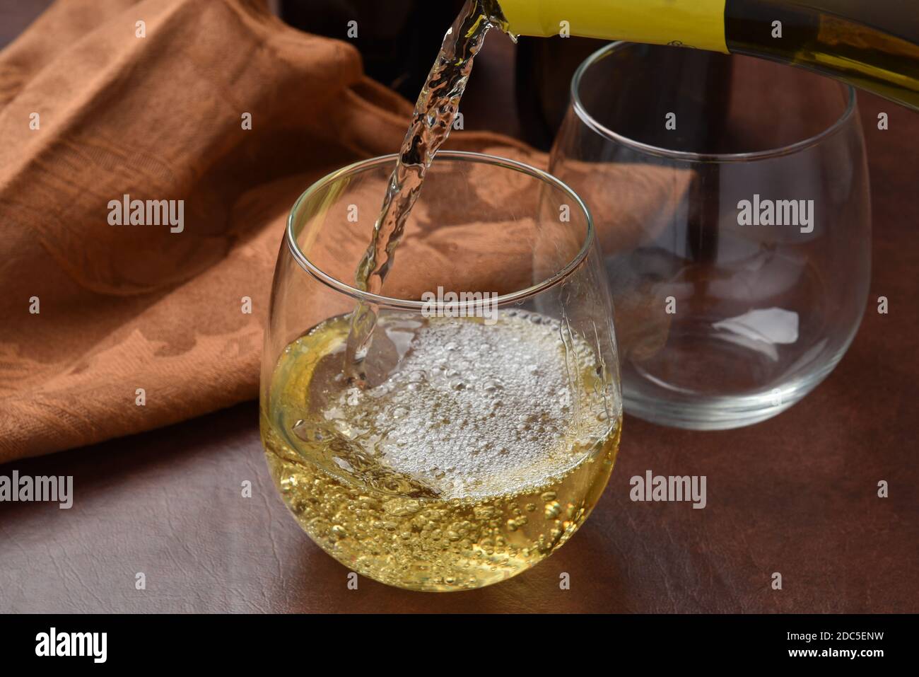 Verser le vin blanc dans un verre, la photographie à grande vitesse, se concentrer sur verser Banque D'Images