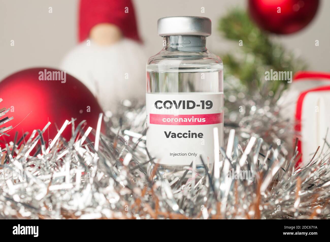 Vaccin contre le coronavirus concept : un flacon de vaccin contre le coronavirus Covid-19, entouré de décorations de Noël Banque D'Images