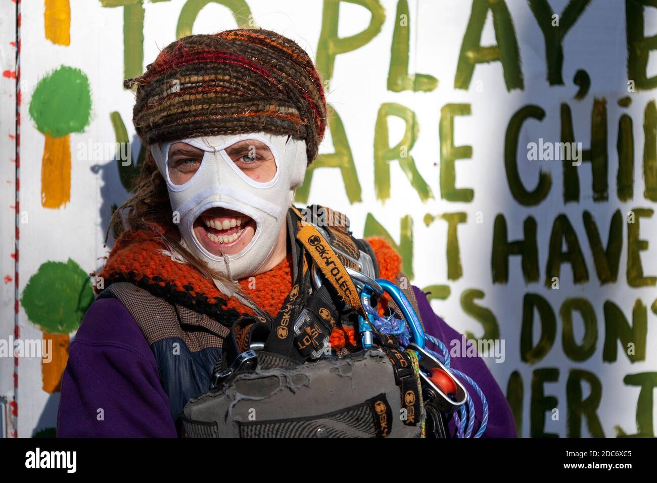 Peacock, activiste de la rébellion contre l'extinction, sourit derrière un masque ignifugé dans un camp de protestation. Dixon Clark court, Highbury Corner. Banque D'Images