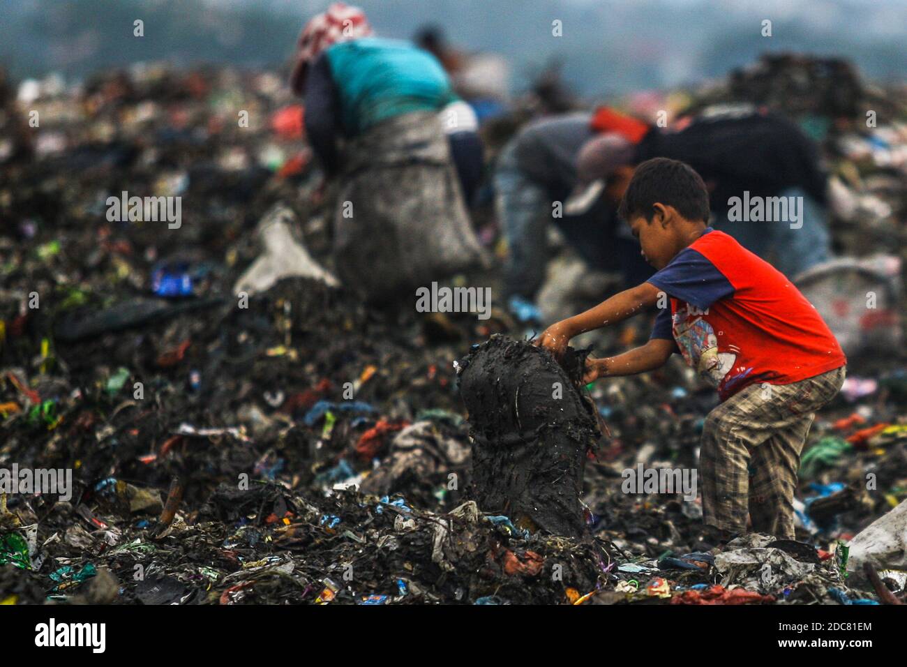 Medan, Sumatera du Nord, Indonésie. 26 octobre 2020. Un enfant d'une communauté de récupération, aide ses parents qui travaillent comme des charneurs à travers une pile de déchets pour le recyclage. En raison de l'impact de la pauvreté urbaine, de nombreux enfants sont touchés à Medan, dans le nord de Sumatra. Crédit : Kartik Byma/SOPA Images/ZUMA Wire/Alay Live News Banque D'Images