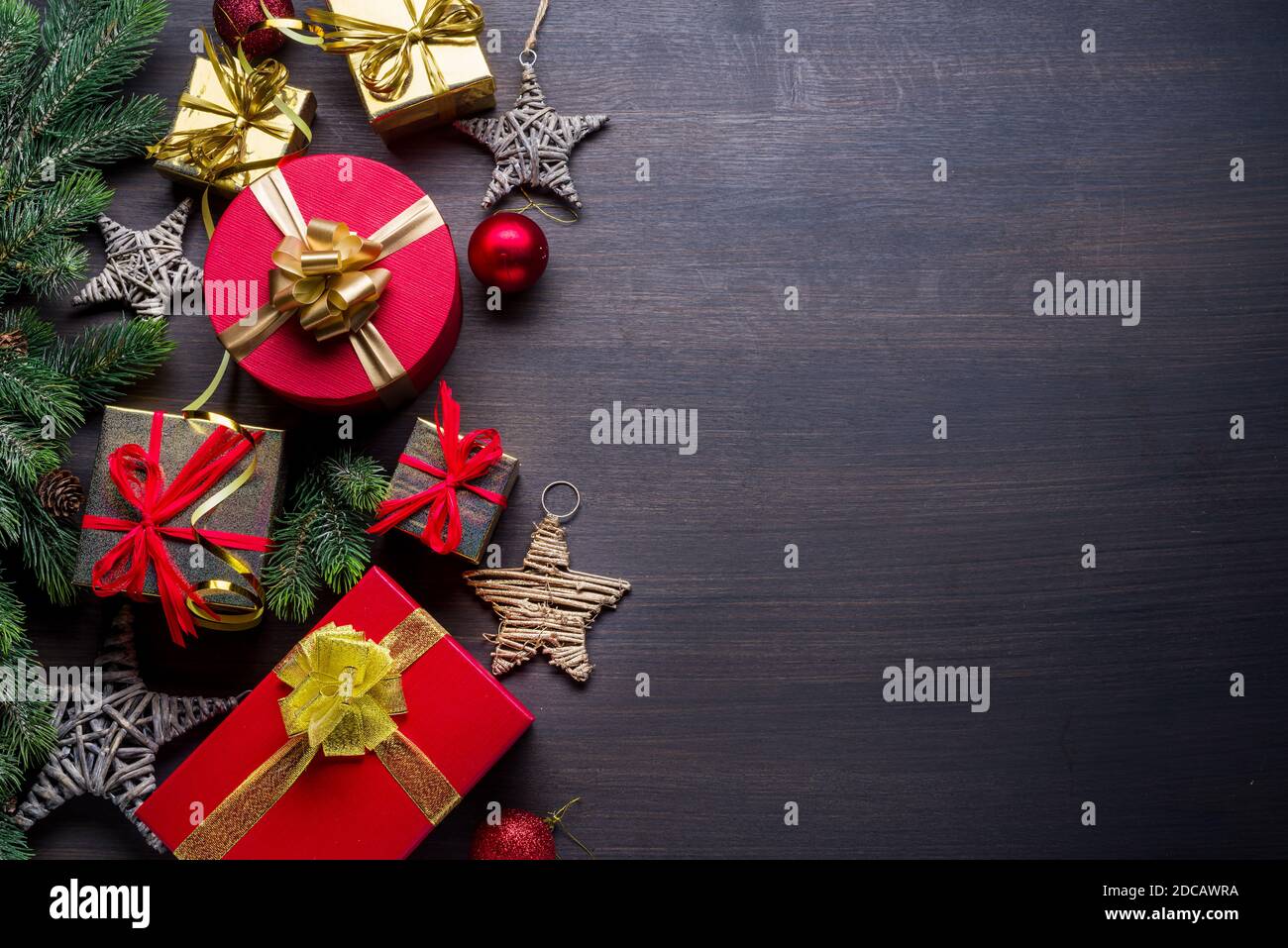 Décoration de Noël, boîtes cadeaux sur table en bois sombre. Le fond de Noël ou de vacances du nouvel an montre la magie des vacances de Noël. Vue de dessus. Banque D'Images