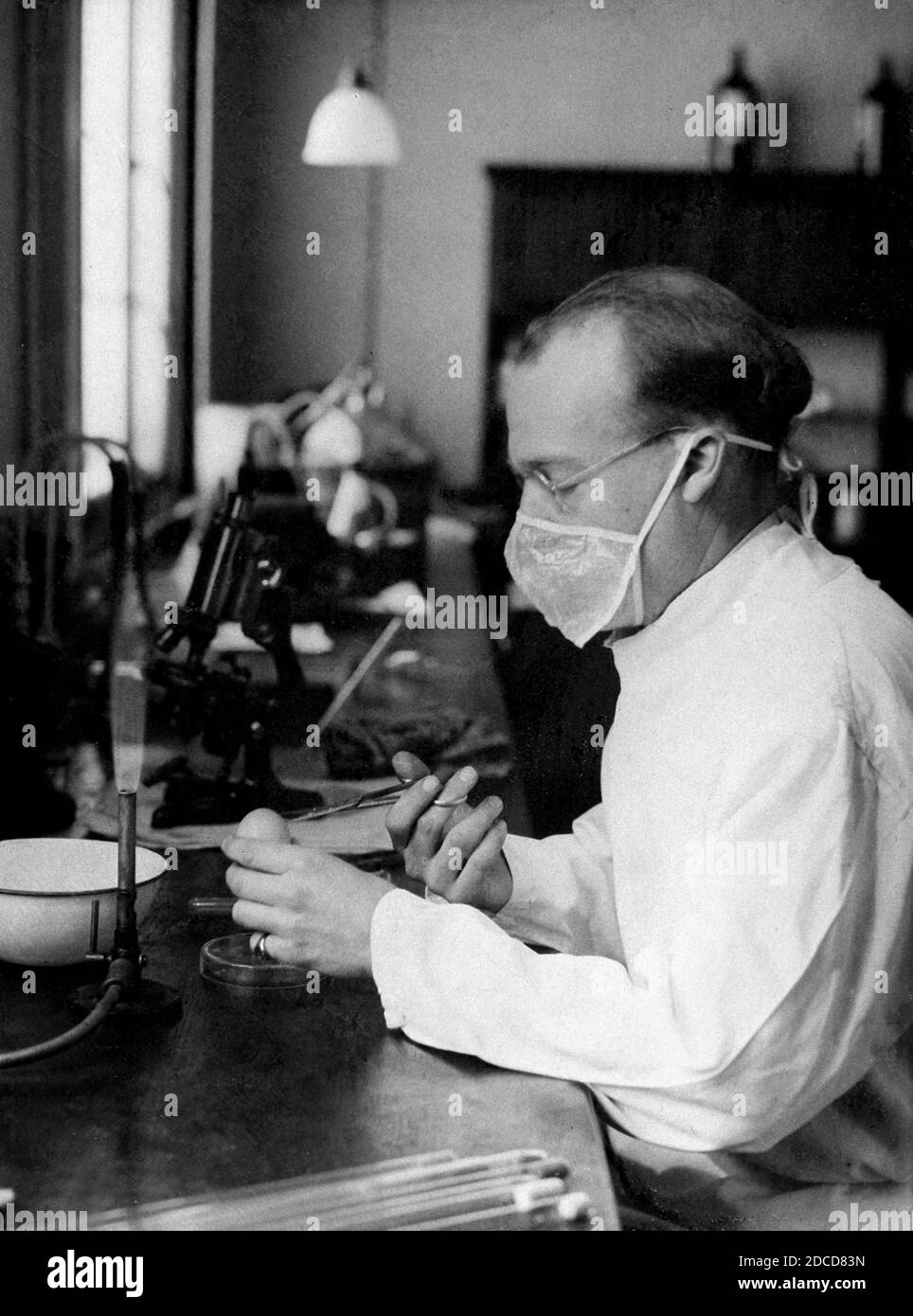 Virologue utilisant le masque facial, c. 1910-1930 Banque D'Images