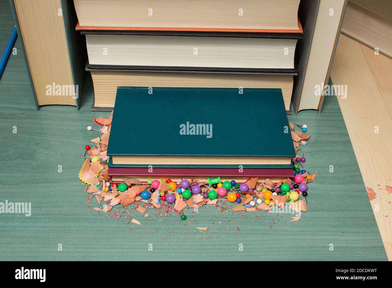 Manuels sur une table en bois avec des pouces et des traces de crayons de couleur. Banque D'Images