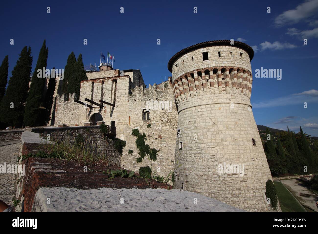 Mur en pierre avec merlons et porte de pont-levis du château médiéval de Brescia dans le nord de l'Italie Banque D'Images