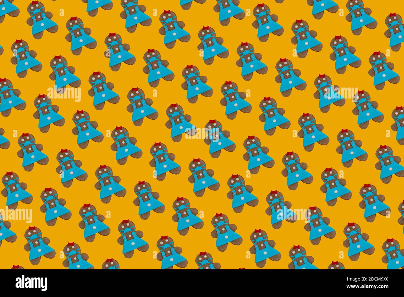 Gingerbread femme n un masque médical. Biscuits sur fond jaune. Gâteries et cadeaux traditionnels doux pour les vacances de Noël et du nouvel an. Banque D'Images