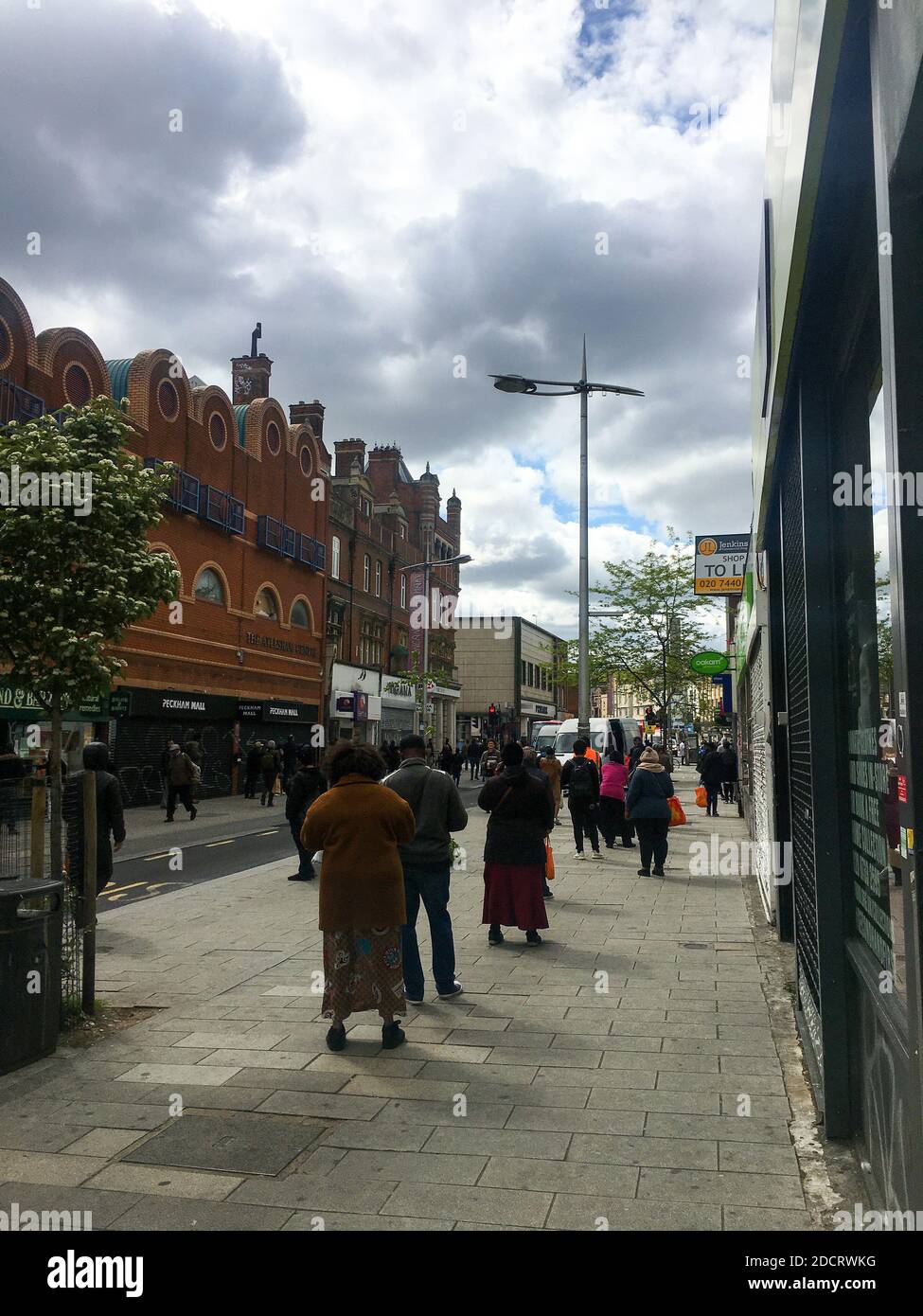 Les gens dans une file d'attente informelle attendant le bus à Peckham Rye dans la deuxième vague de la pandémie de COVID 19 Banque D'Images