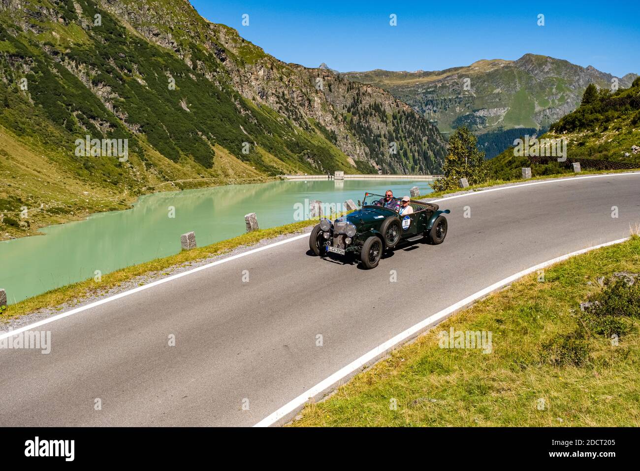 Une voiture ancienne BENTLEY 3 1/2 LITRES VAN DEN PLAS en passant devant un lac sur Silvretta Hochalpenstrasse pendant le rallye automobile Arlberg Classic. Banque D'Images