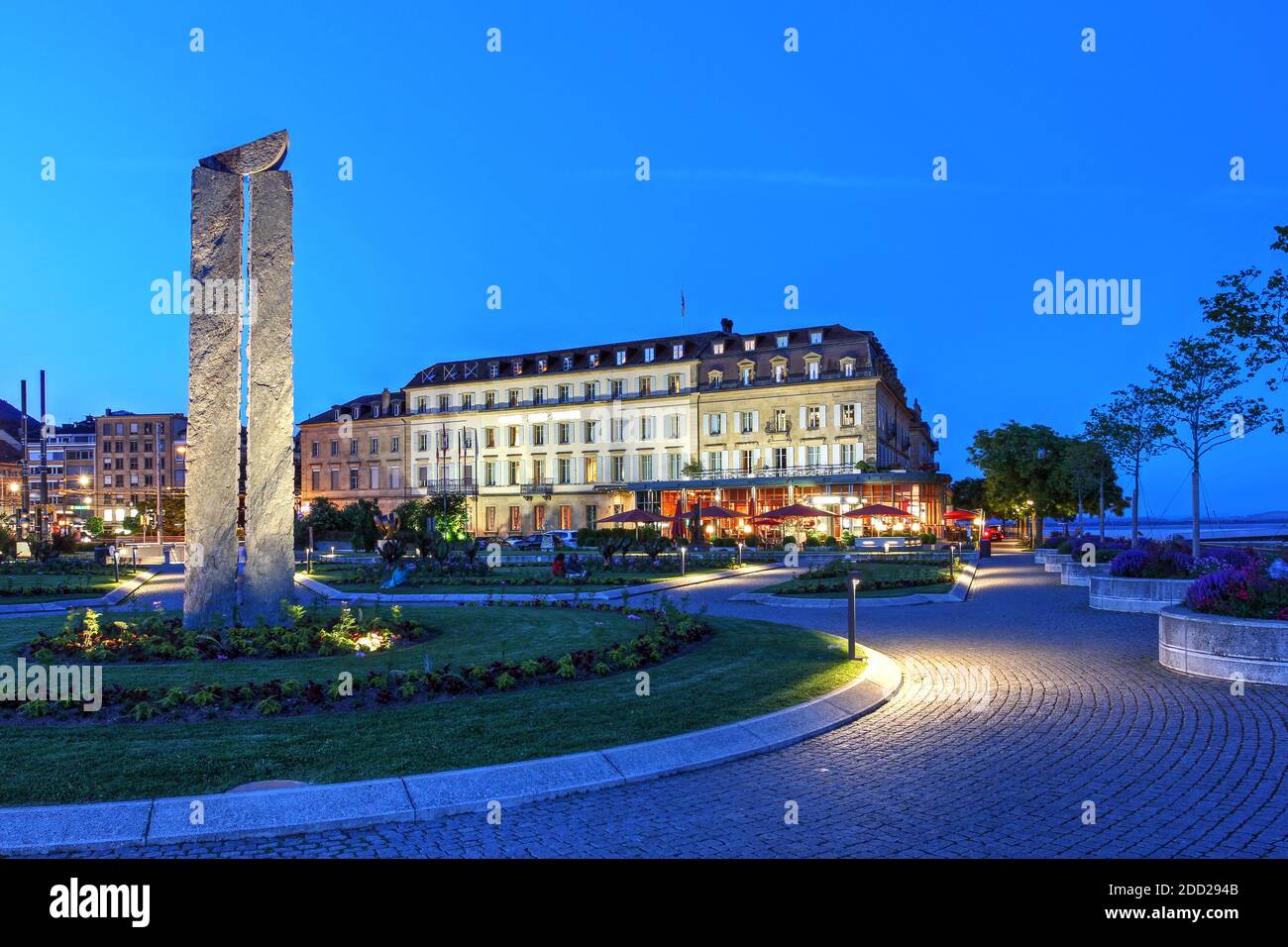 Coucher de soleil sur l'Esplanade du Mont blanc à Neuchâtel, en Suisse, avec une œuvre de l'artiste suisse René Kueng et l'historique Hotel beau-Rivage. Banque D'Images