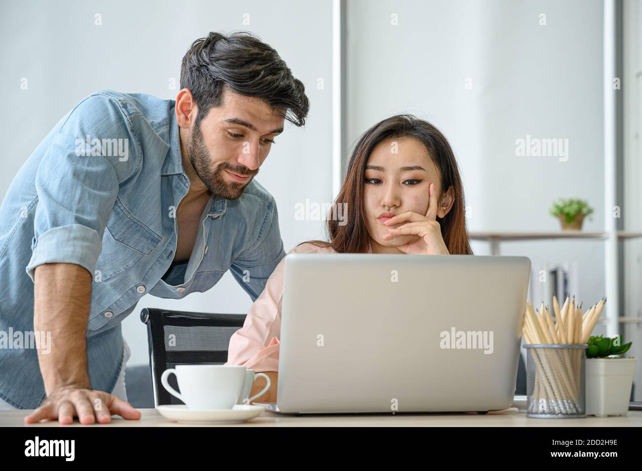 Joyeux et détendu style de vie de jeune amoureux de couple portant une robe décontractée ensemble travailler sur ordinateur portable ordinateur portable dans le salon à la maison. Positif RE Banque D'Images