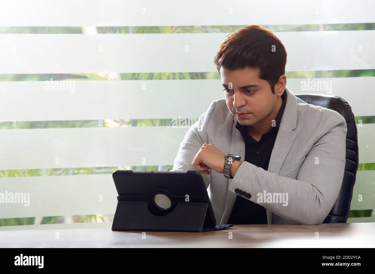 PORTRAIT D'UN JEUNE HOMME TRAVAILLANT AU BUREAU Banque D'Images