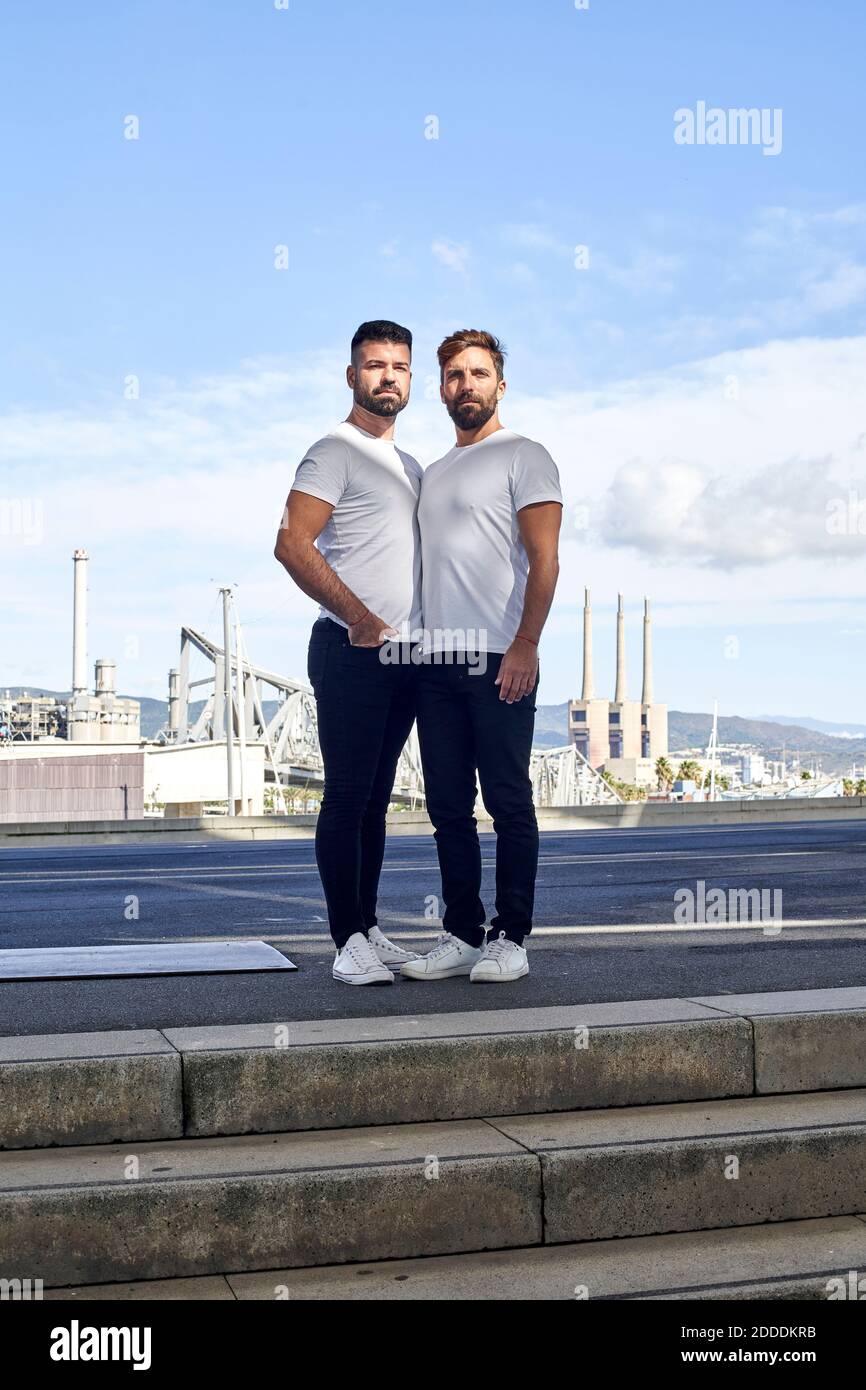 Couple gay confiant debout sur le pont contre le ciel Banque D'Images
