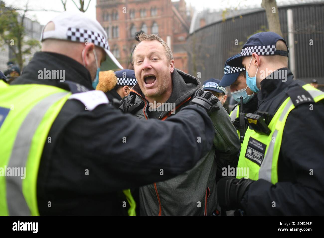 Un homme est détenu par la police lors d'une manifestation anti-verrouillage à Kings Cross St Pancras, Londres. Banque D'Images