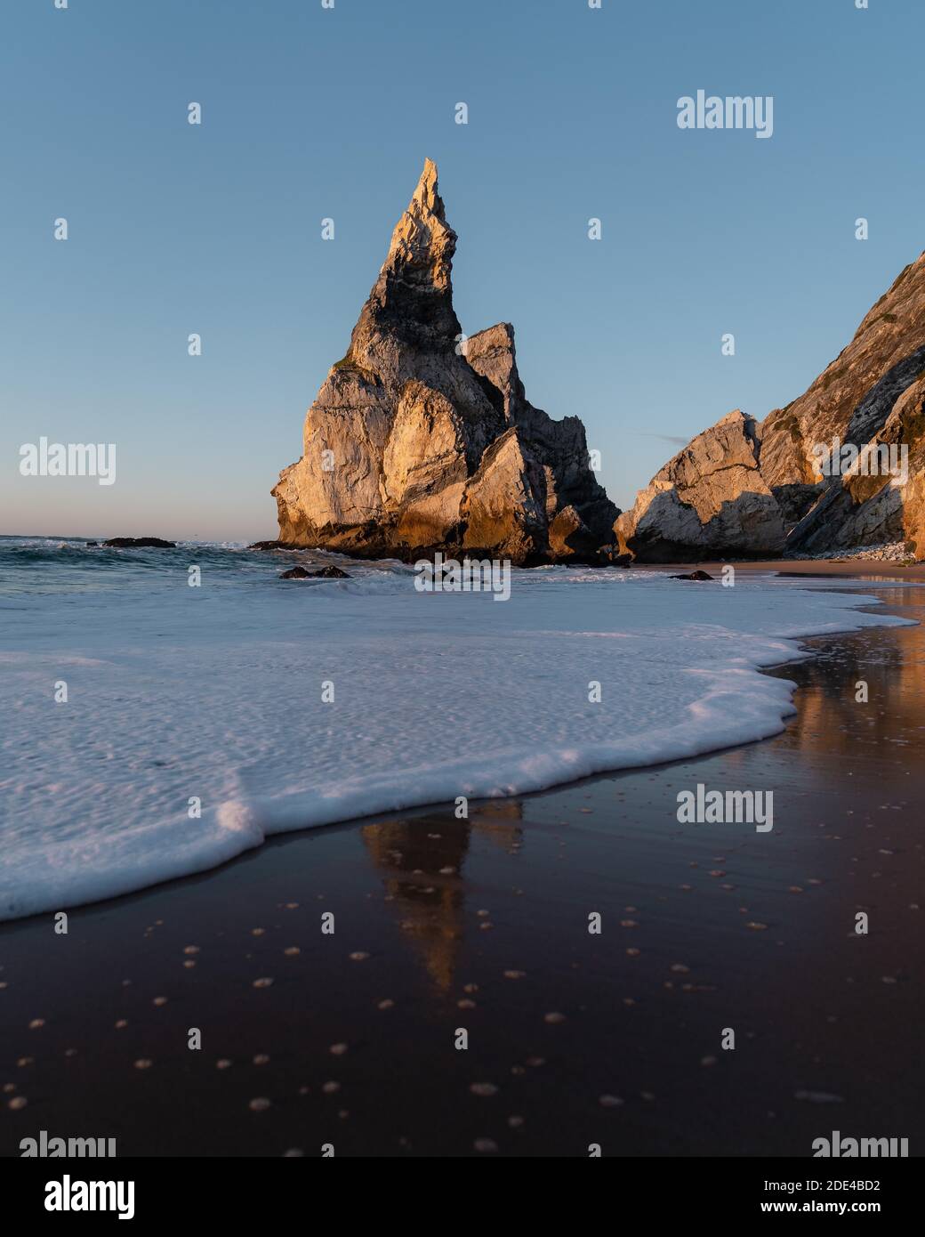 Rochers marqués à la plage de Praia da Ursa avec réflexion et eau de mer mousseuse, Ulgueira, Portugal Banque D'Images