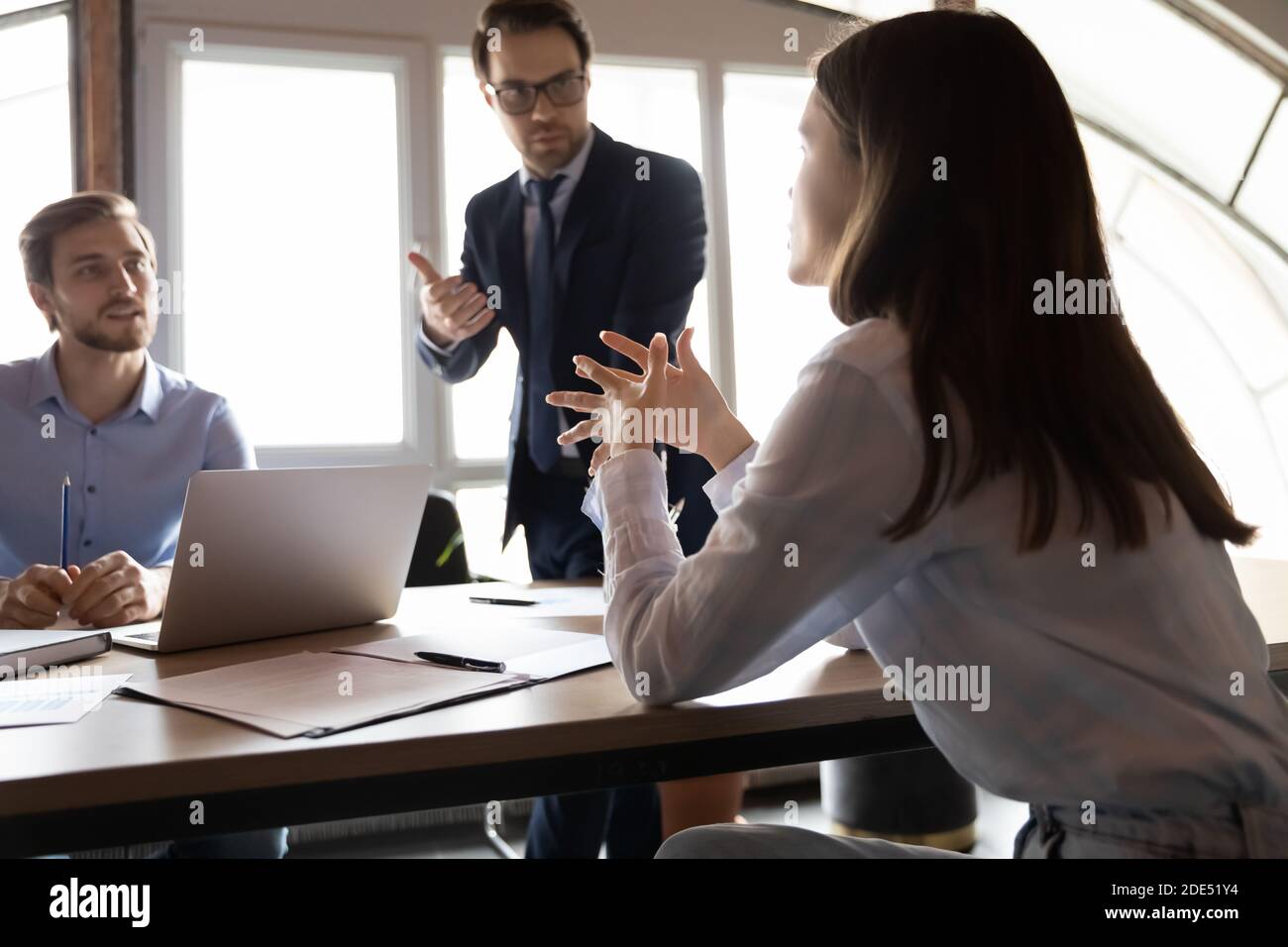 A inspiré une employée féminine exprimant son idée à des collègues masculins attentifs Banque D'Images