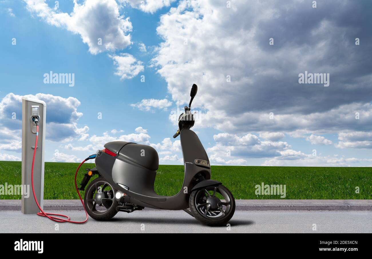 Scooter électrique avec station de charge sur fond vert champ et ciel bleu  Photo Stock - Alamy