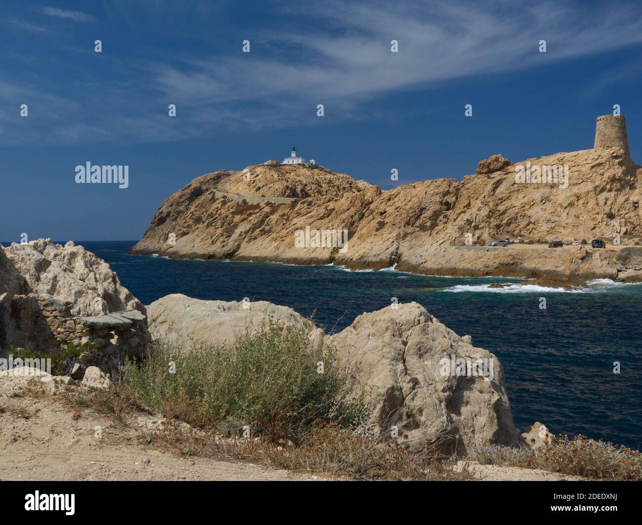 Phare de Pietra sur le cap rocheux raide dedans Corse du Nord sous un ciel bleu vif Banque D'Images