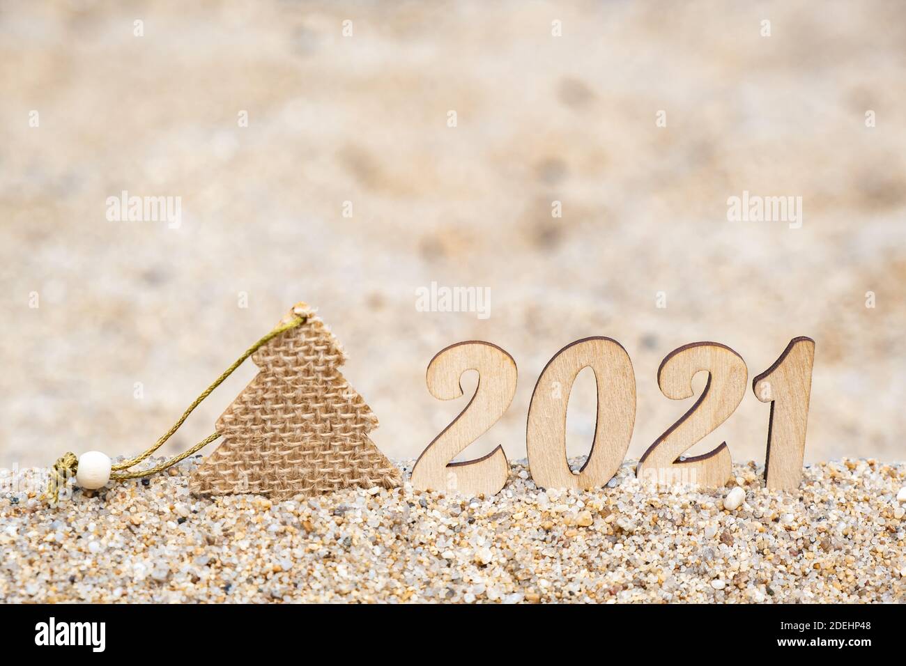 Carte de Noël créative. 2021 numéros sur la plage sur le sable avec un arbre de Noël. Concept de tourisme et de loisirs. Mise au point sélective. Copier l'espace. Banque D'Images